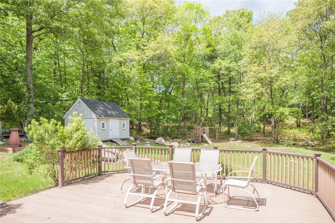 2097 Middle Road East Greenwich, RI 02818 - Photo 26 of 29 Large backyard composite deck with a great view of the 2 acre lot. The generous sized 2 compartment shed offers lots of additional storage.