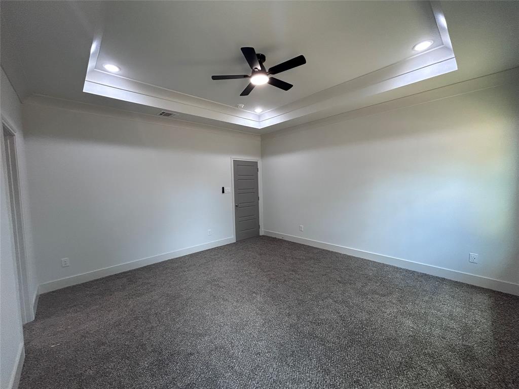 2110 Ridgewood Drive Bridgeport, TX 76426 - Photo 10 of 34 Master bedroom with a tray ceiling, ceiling fan, carpet floors, and recessed lighting