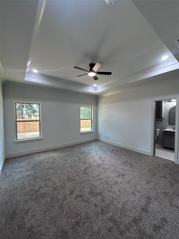 2110 Ridgewood Drive Bridgeport, TX 76426 - Photo 11 of 34 Master bedroom featuring a tray ceiling, a ceiling fan, recessed lighting, and crown molding