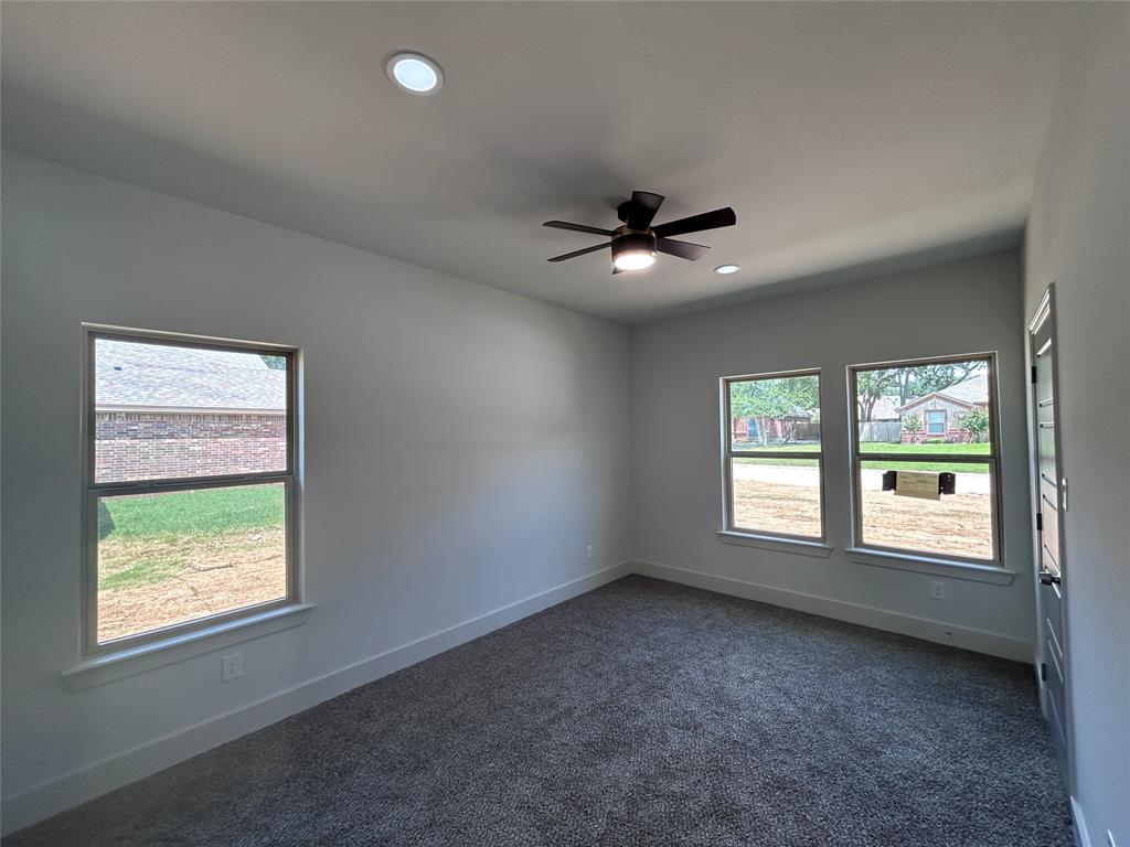 2110 Ridgewood Drive Bridgeport, TX 76426 - Photo 21 of 34 Bedroom with healthy amount of natural light, dark colored carpet, a ceiling fan, and recessed lighting