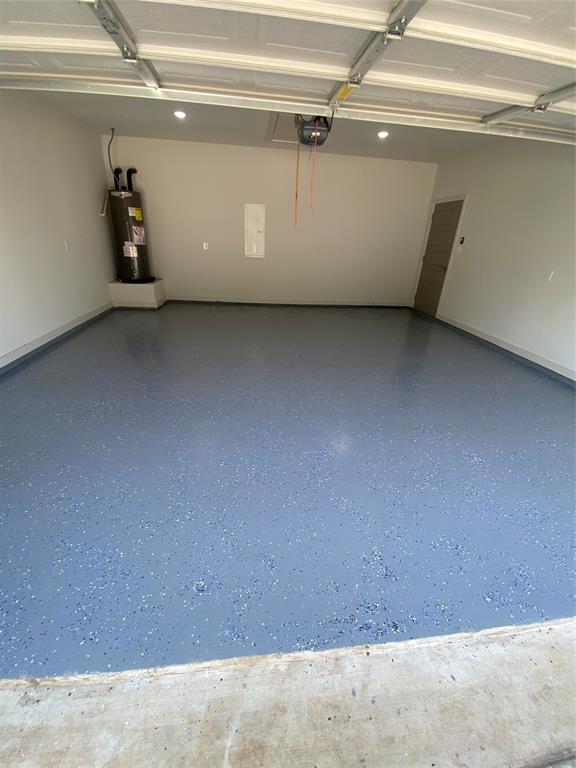 2110 Ridgewood Drive Bridgeport, TX 76426 - Photo 31 of 34 Garage featuring water heater and a garage door opener