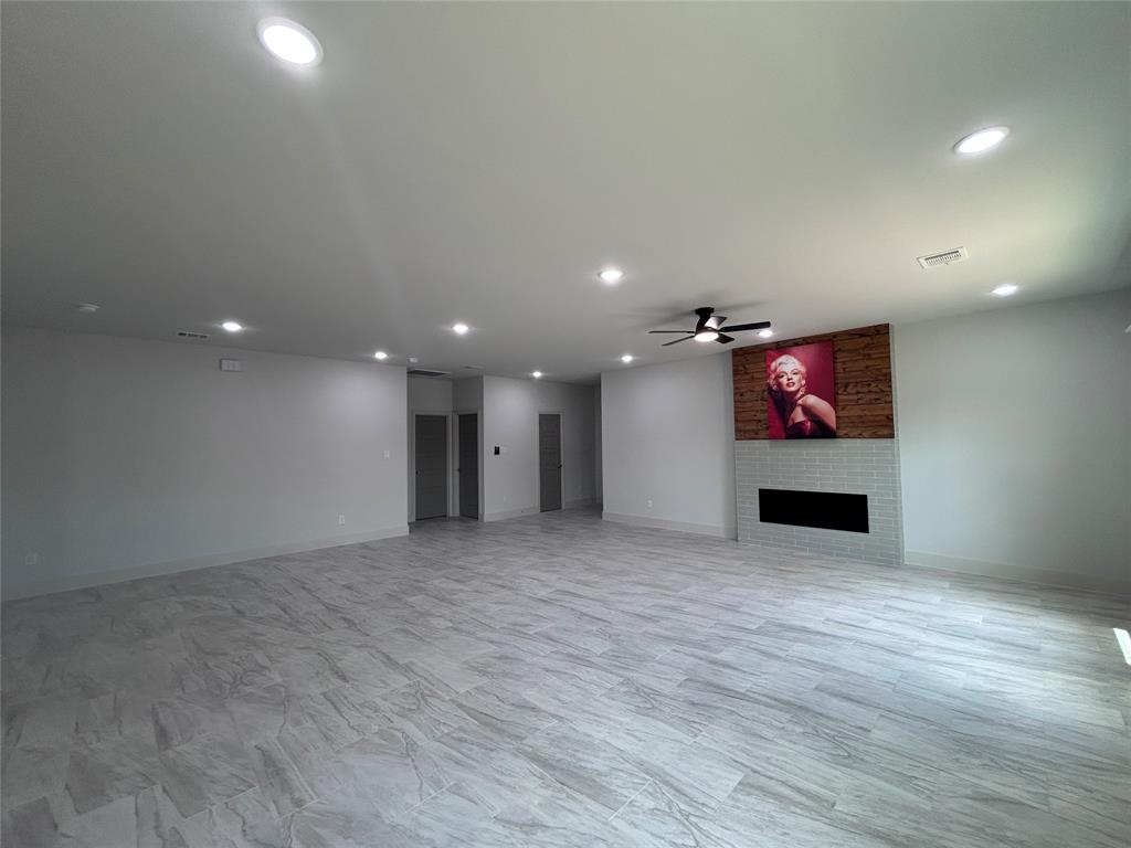 2110 Ridgewood Drive Bridgeport, TX 76426 - Photo 4 of 34 Unfurnished living room featuring recessed lighting, a large fireplace, and a ceiling fan