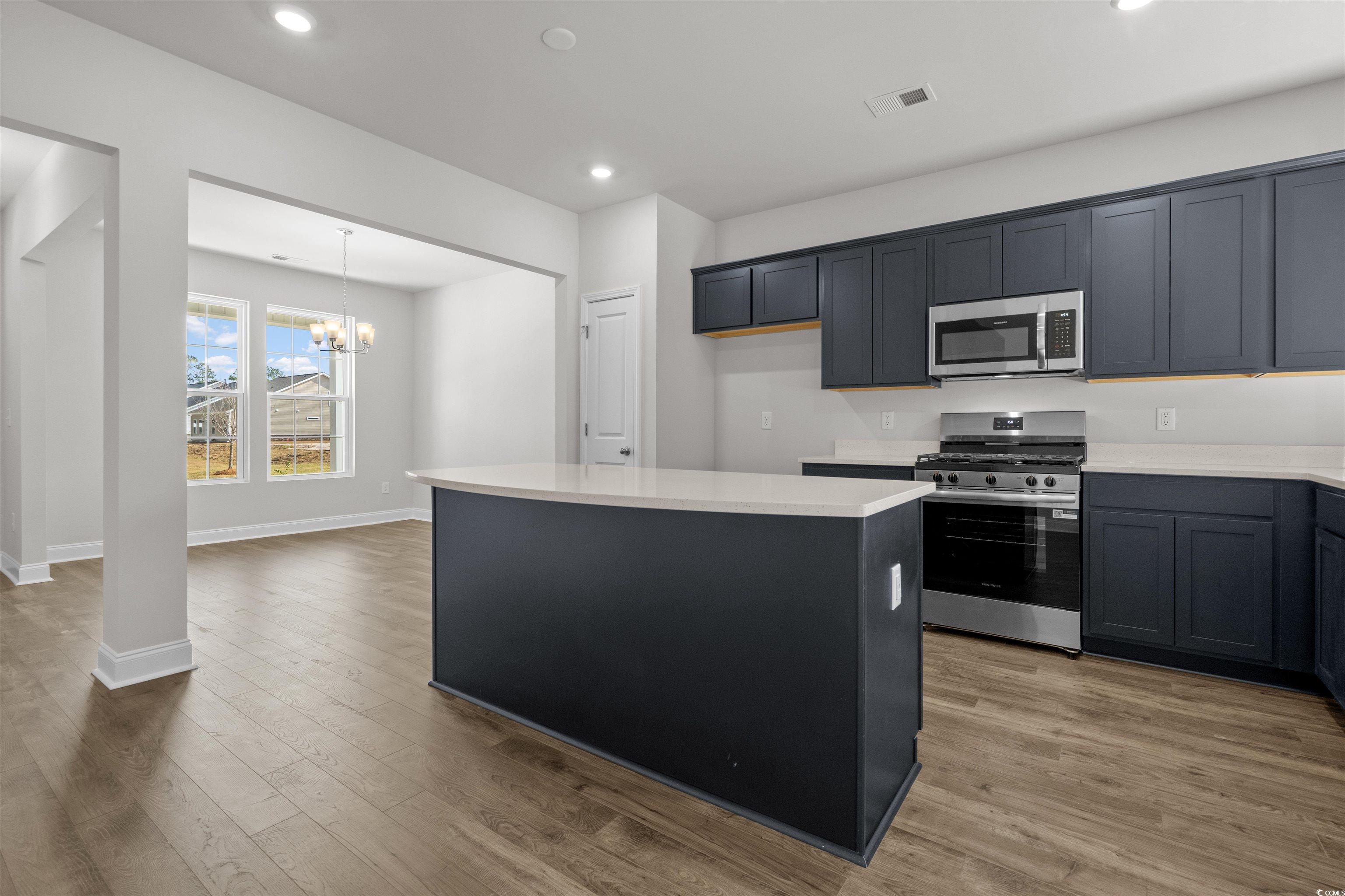 3013 Spain Lane Conway, SC 29527 - Photo 16 of 40 Kitchen with a center island, appliances with stainless steel finishes, a chandelier, recessed lighting, and light wood finished floors