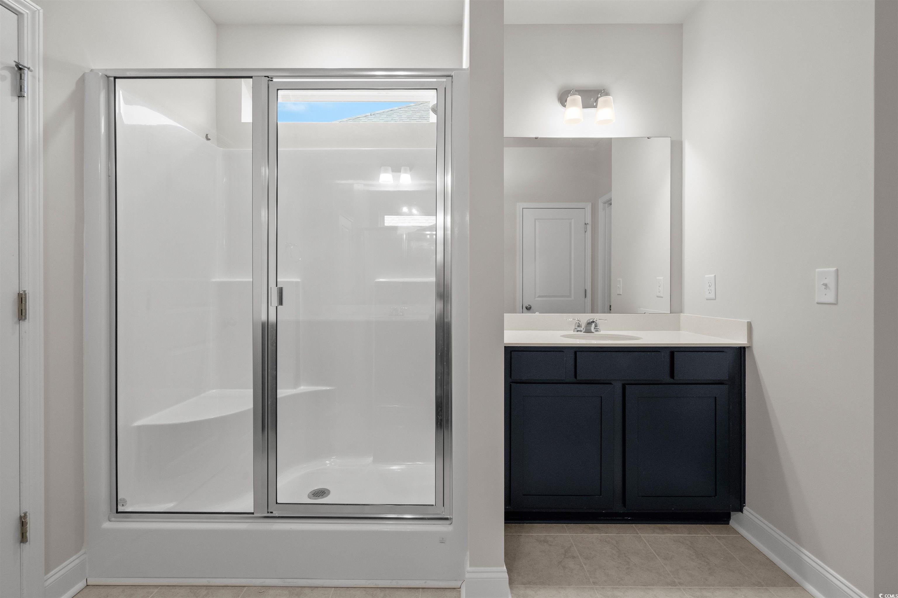 3013 Spain Lane Conway, SC 29527 - Photo 27 of 40 Bathroom with vanity, a shower stall, and light tile patterned floors
