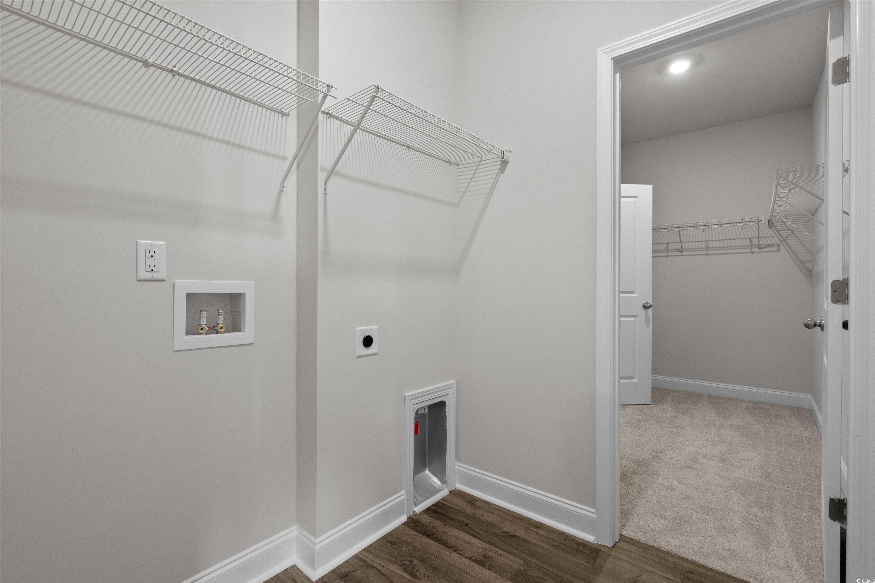 3013 Spain Lane Conway, SC 29527 - Photo 38 of 40 Laundry room with wood finished floors, hookup for an electric dryer, washer hookup, and carpet flooring