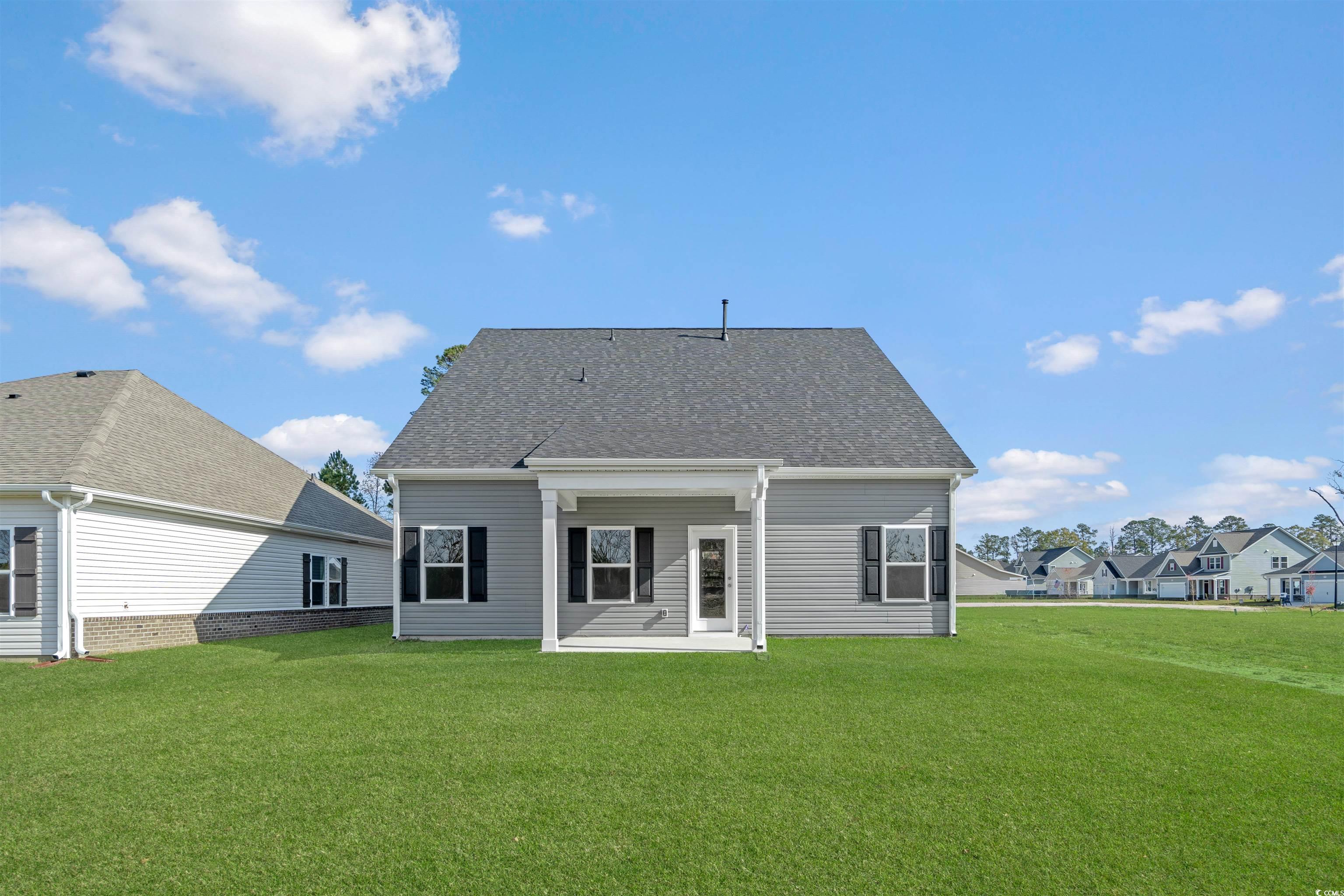 3013 Spain Lane Conway, SC 29527 - Photo 39 of 40 Rear view of house featuring a patio, a lawn, a shingled roof, and a residential view