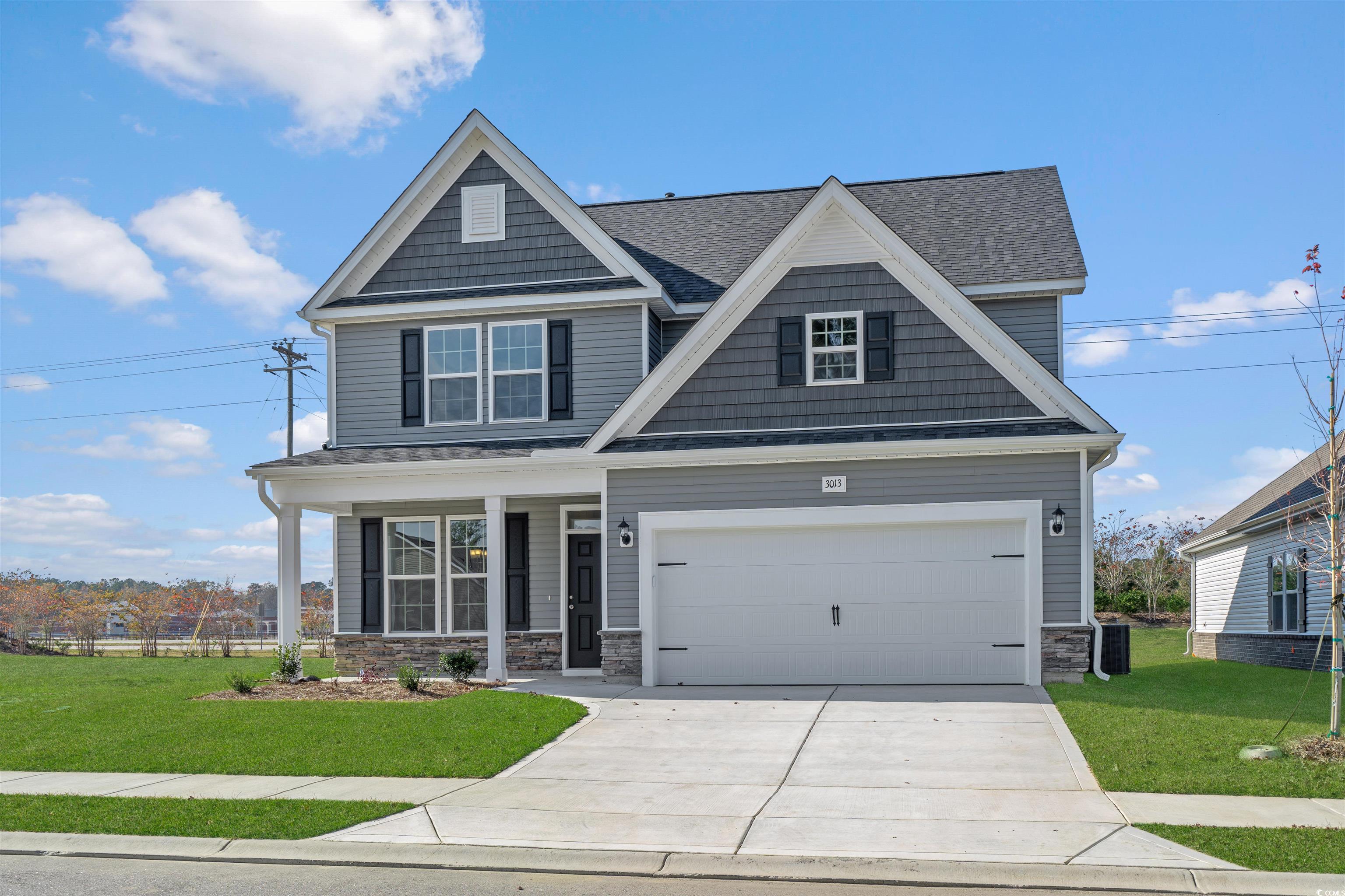 3013 Spain Lane Conway, SC 29527 - Photo 40 of 40 Craftsman-style house featuring stone siding, a porch, a shingled roof, and concrete driveway