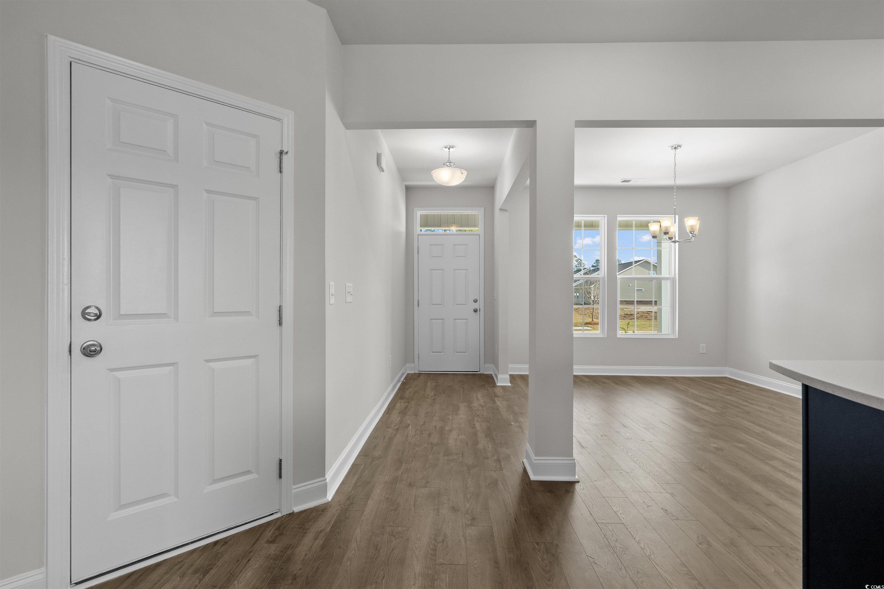 3013 Spain Lane Conway, SC 29527 - Photo 5 of 40 Entryway with dark wood-type flooring and a chandelier