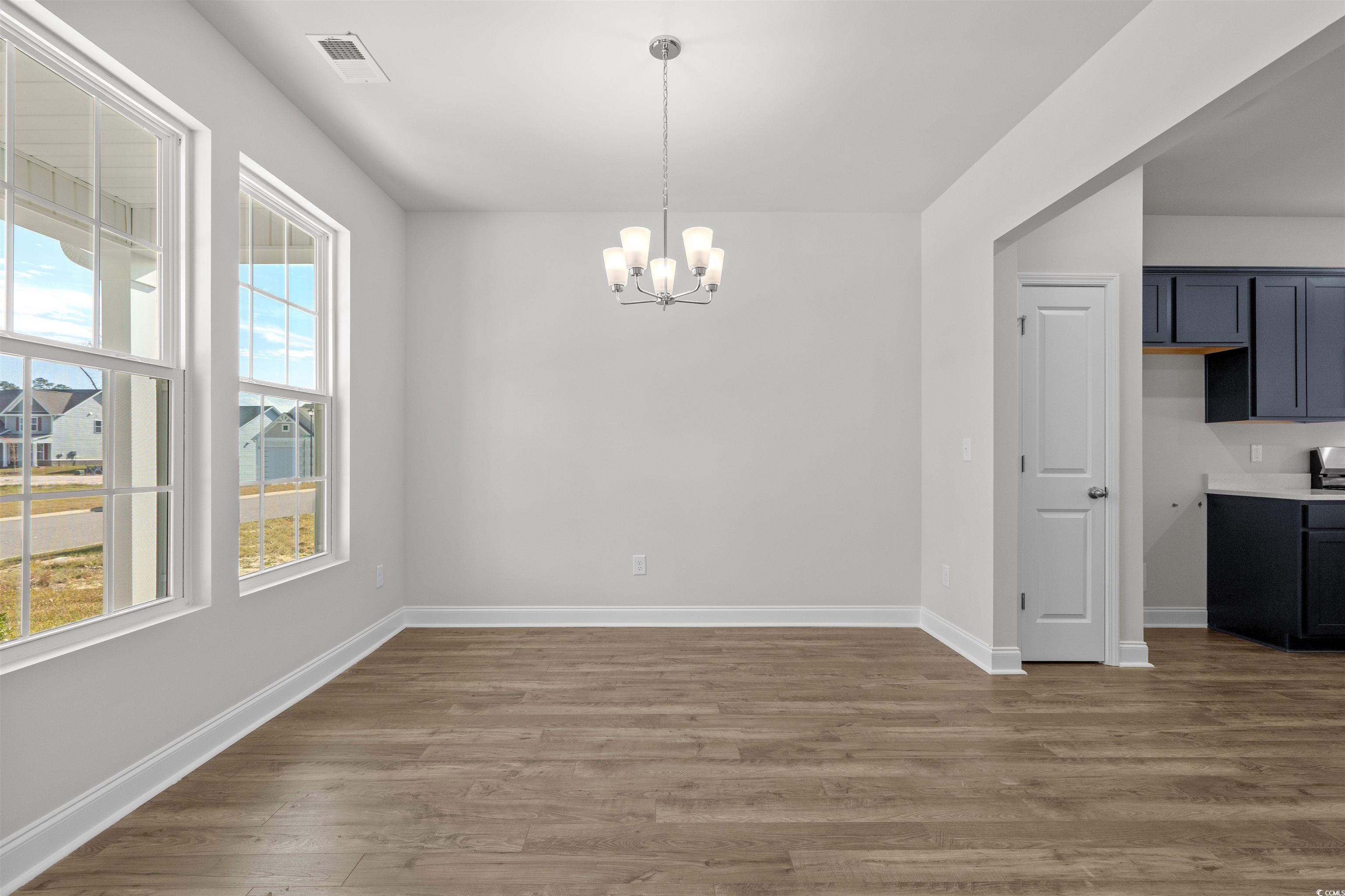 3013 Spain Lane Conway, SC 29527 - Photo 6 of 40 Unfurnished dining area with a chandelier and dark wood-style floors