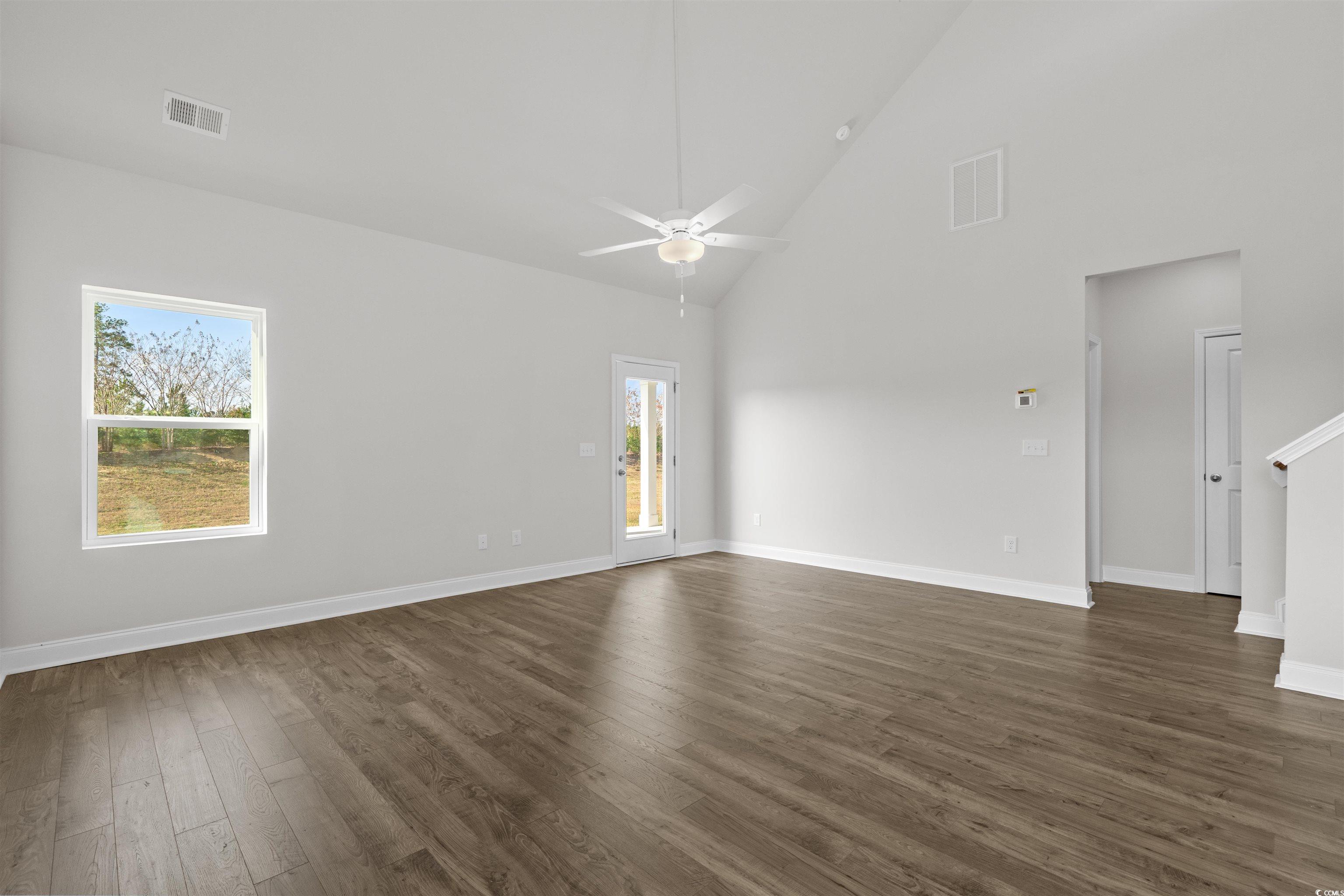 3013 Spain Lane Conway, SC 29527 - Photo 10 of 40 Empty room featuring high vaulted ceiling, dark wood finished floors, and a ceiling fan