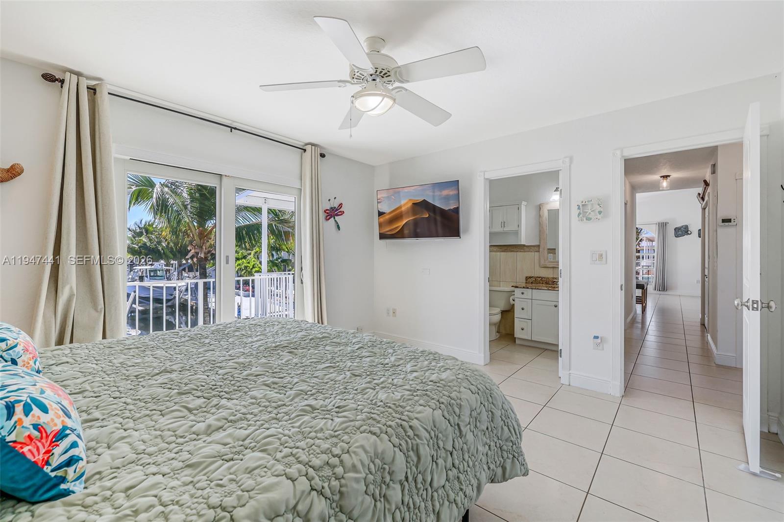 21 Mangrove Lane Key Largo, FL 33037 - Photo 13 of 48 a bedroom with a bed and a large mirror