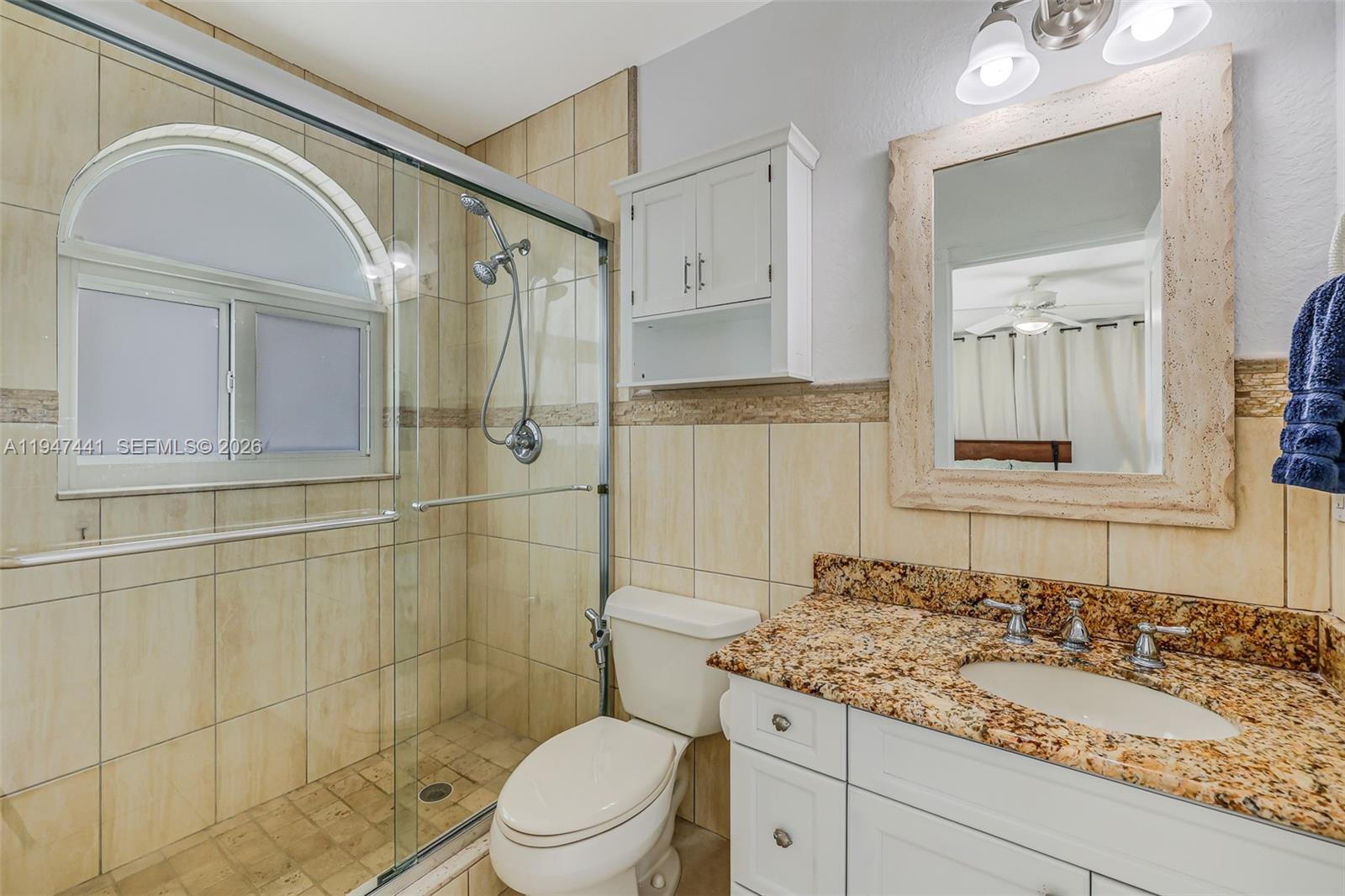 21 Mangrove Lane Key Largo, FL 33037 - Photo 15 of 48 a bathroom with a granite countertop sink toilet and shower