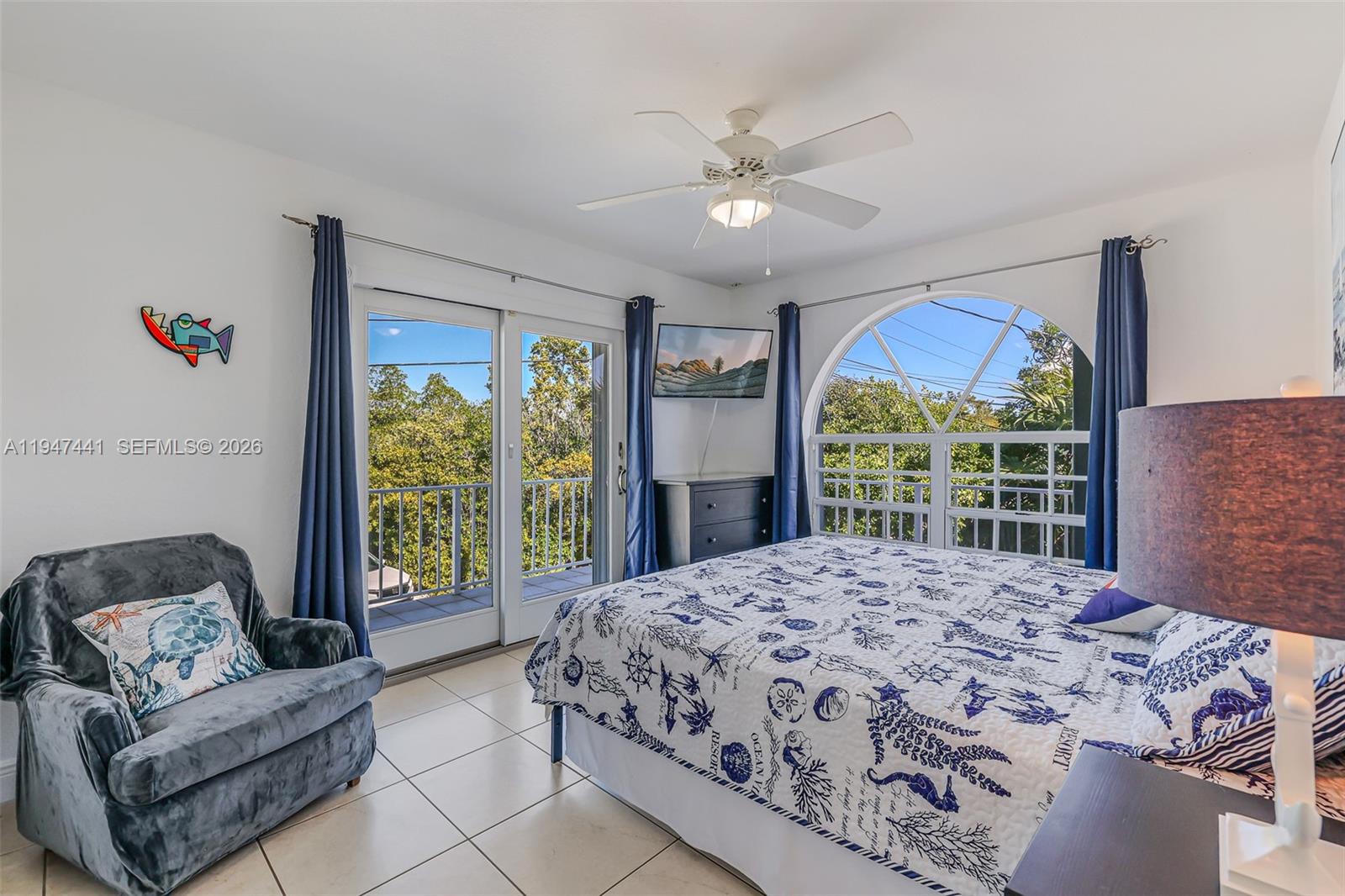 21 Mangrove Lane Key Largo, FL 33037 - Photo 16 of 48 a bedroom with a balcony a bed and a large window