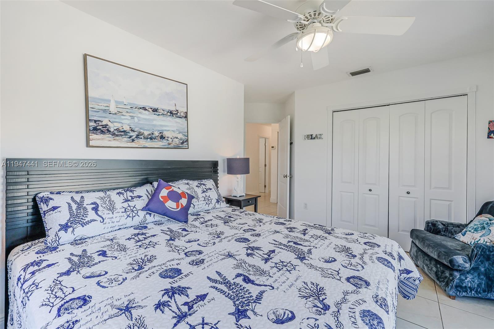 21 Mangrove Lane Key Largo, FL 33037 - Photo 18 of 48 a bedroom with a bed and a chandelier