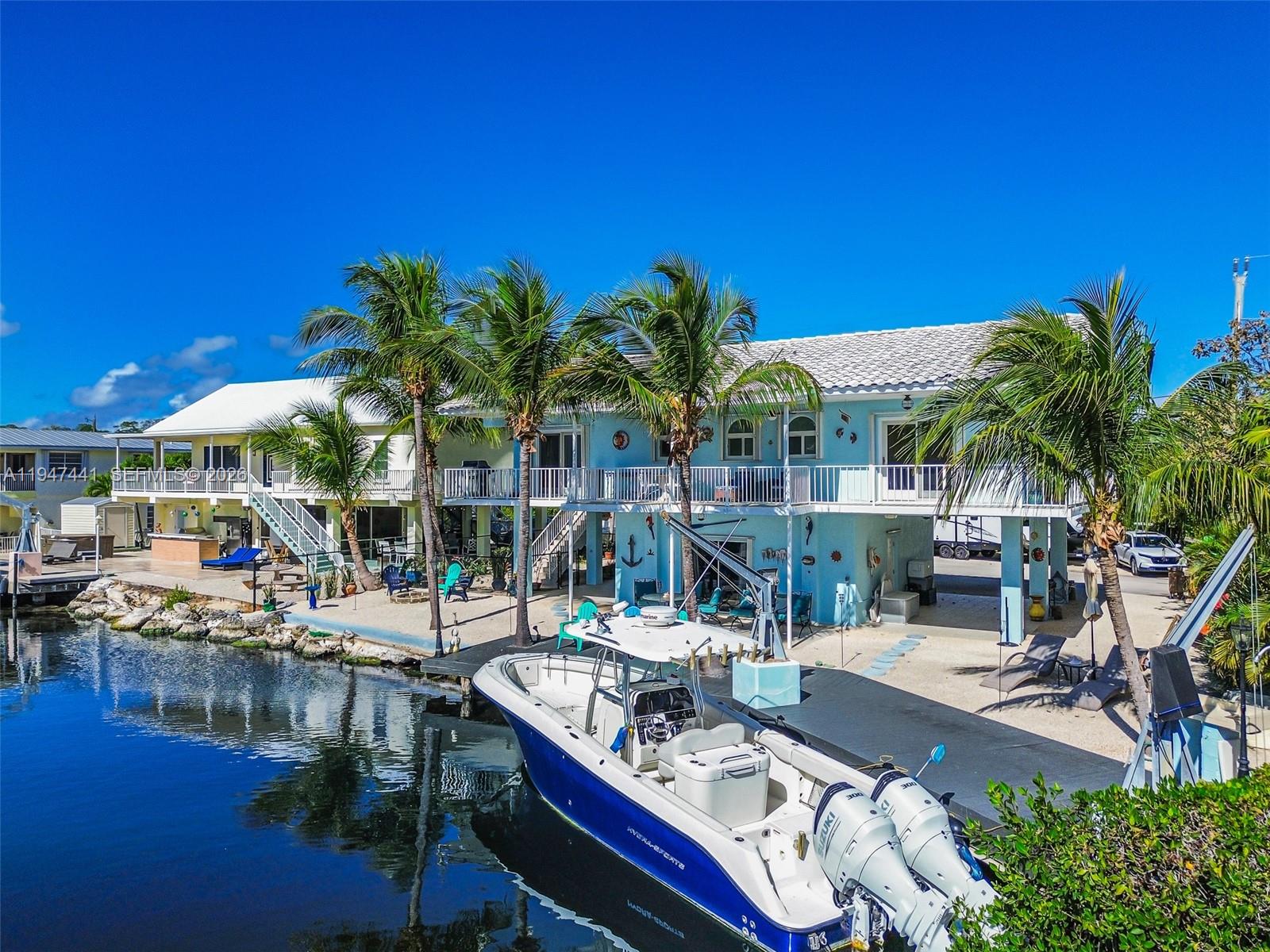 21 Mangrove Lane Key Largo, FL 33037 - Photo 2 of 48 a view of a swimming pool with outdoor seating