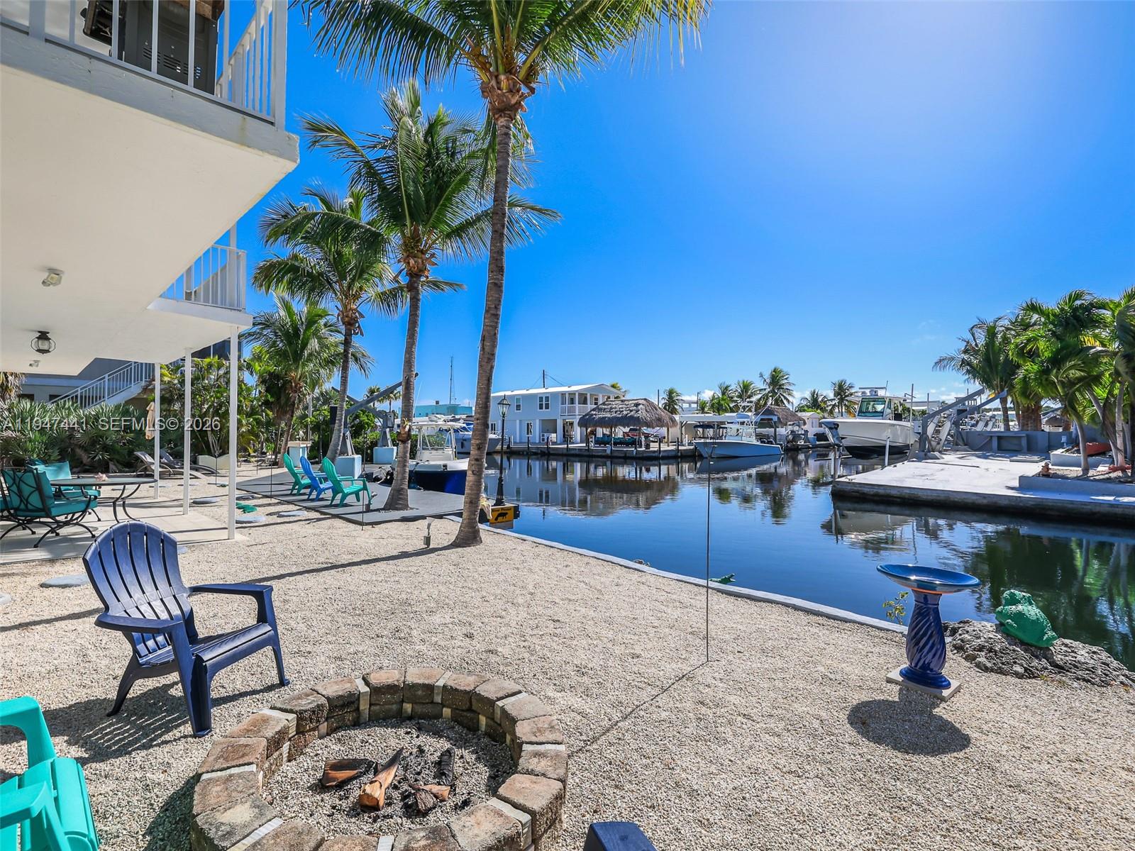 21 Mangrove Lane Key Largo, FL 33037 - Photo 25 of 48 a view of a chairs and table in the patio