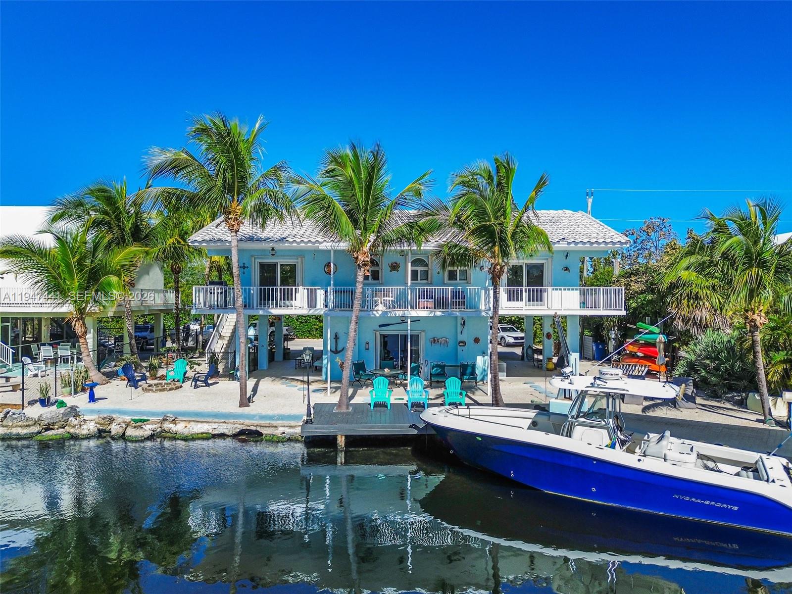21 Mangrove Lane Key Largo, FL 33037 - Photo 28 of 48 a swimming pool with outdoor seating and yard