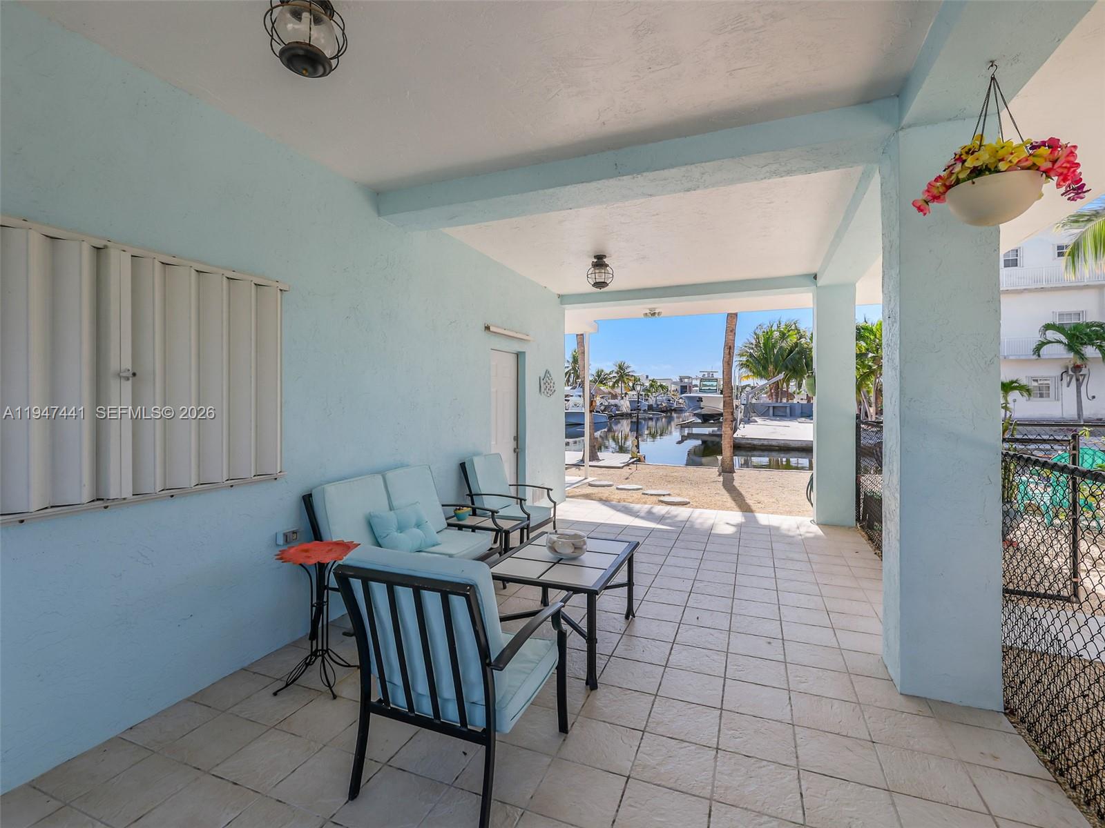 21 Mangrove Lane Key Largo, FL 33037 - Photo 30 of 48 a view of a dining room with furniture and a potted plant