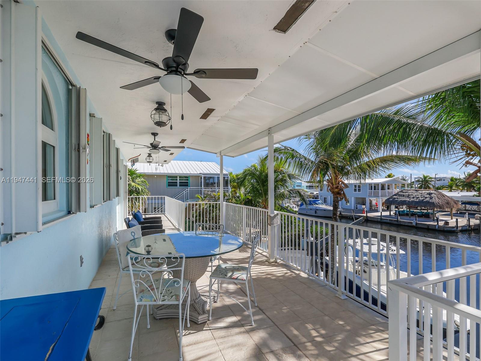 21 Mangrove Lane Key Largo, FL 33037 - Photo 34 of 48 a view of a patio with a table and chairs