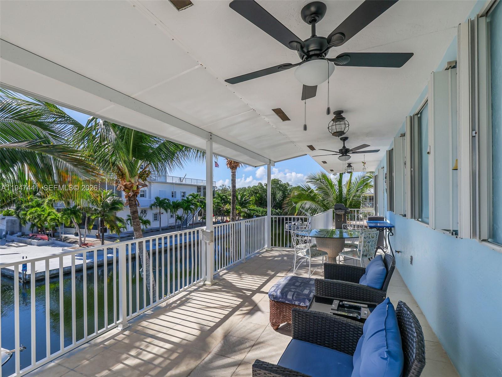 21 Mangrove Lane Key Largo, FL 33037 - Photo 35 of 48 a living room with patio furniture and a floor to ceiling window