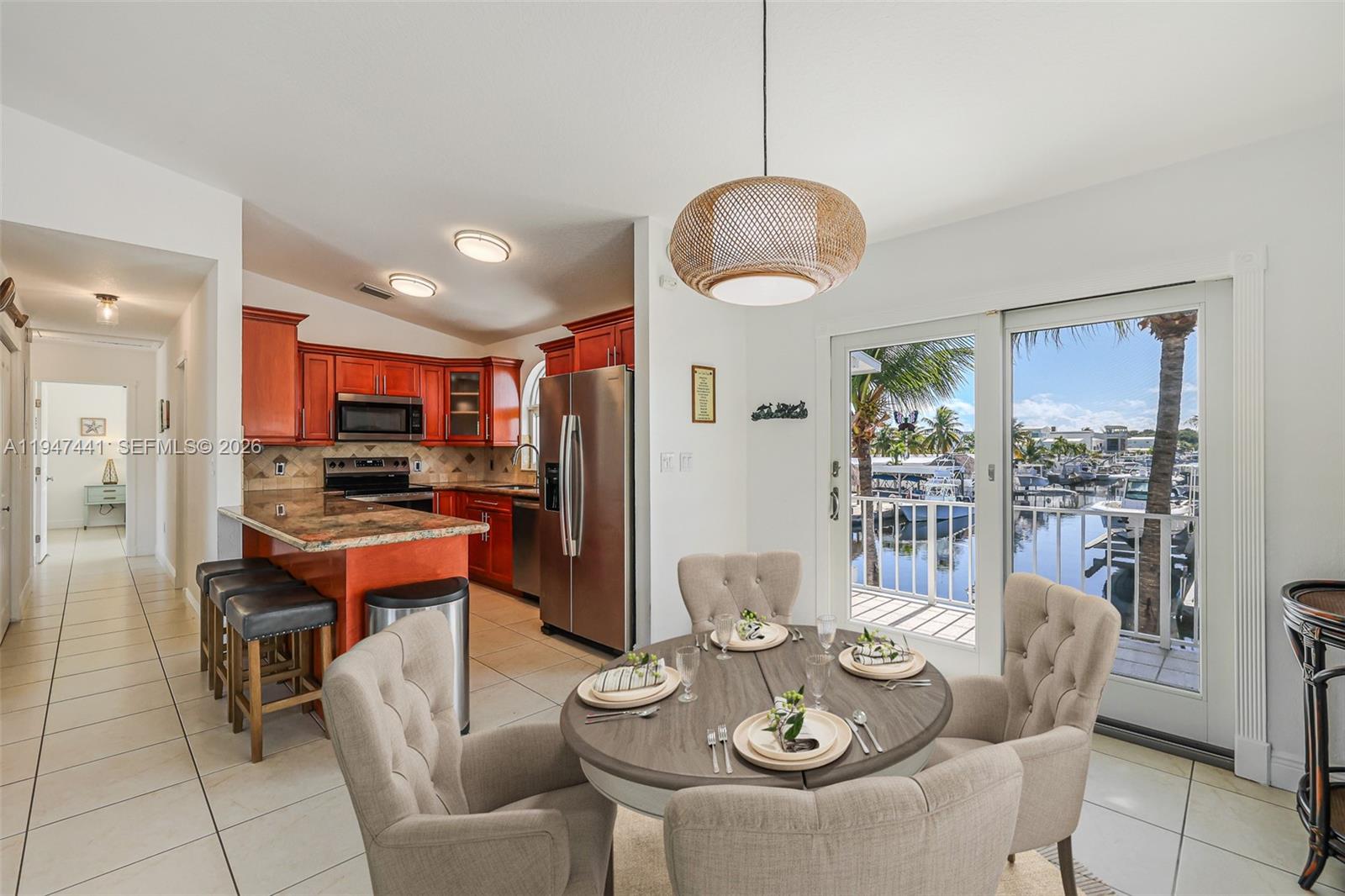 21 Mangrove Lane Key Largo, FL 33037 - Photo 7 of 48 a view of a dining room with furniture a kitchen and chandelier
