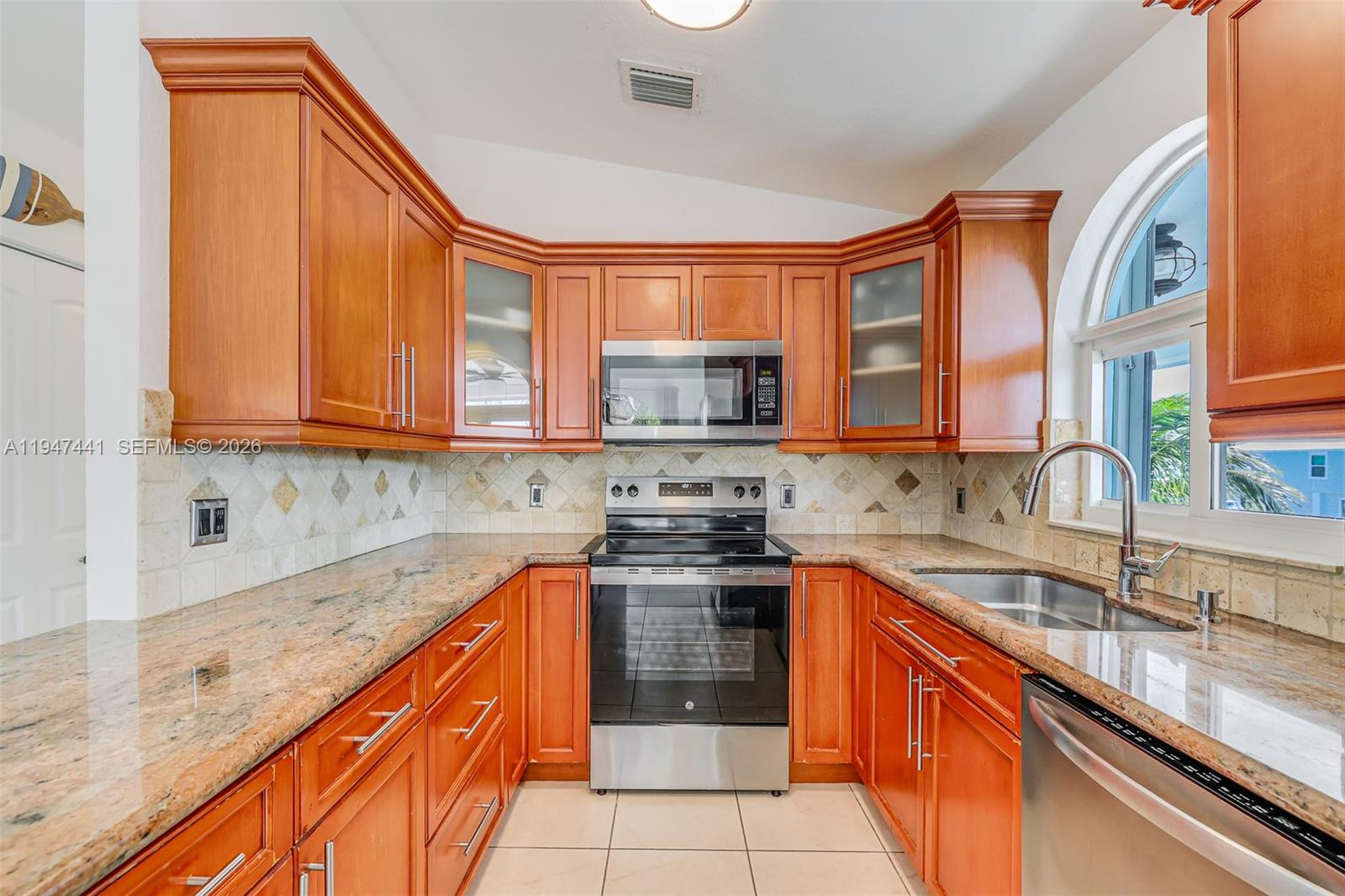 21 Mangrove Lane Key Largo, FL 33037 - Photo 8 of 48 a kitchen with stainless steel appliances granite countertop a sink and a stove