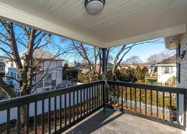 a view of balcony with wooden floor