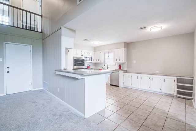 a kitchen with cabinets and white appliances