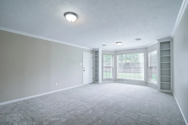 a view of an empty room with a window
