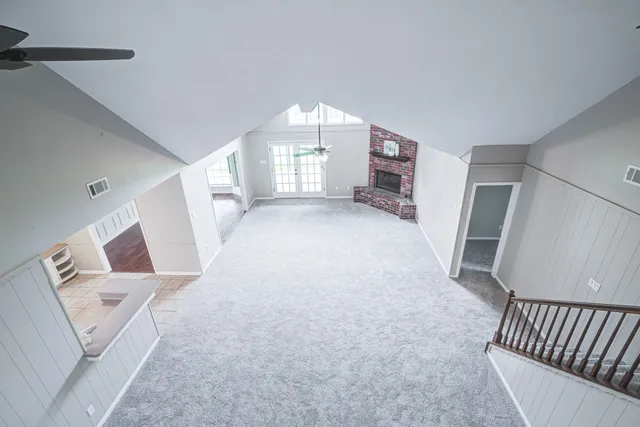 a view of a livingroom with furniture and staircase