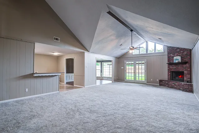 a view of a livingroom with a fireplace and window