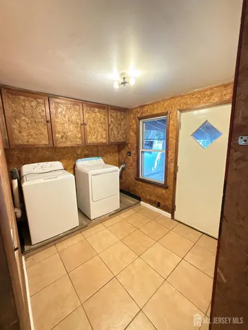 a bedroom with windows and a table