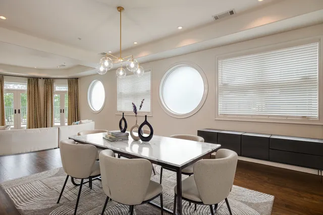a view of a dining room with furniture and chandelier
