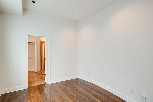 a view of a room with wooden floor