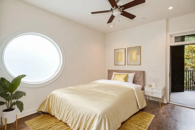 a bedroom with a bed and a potted plant