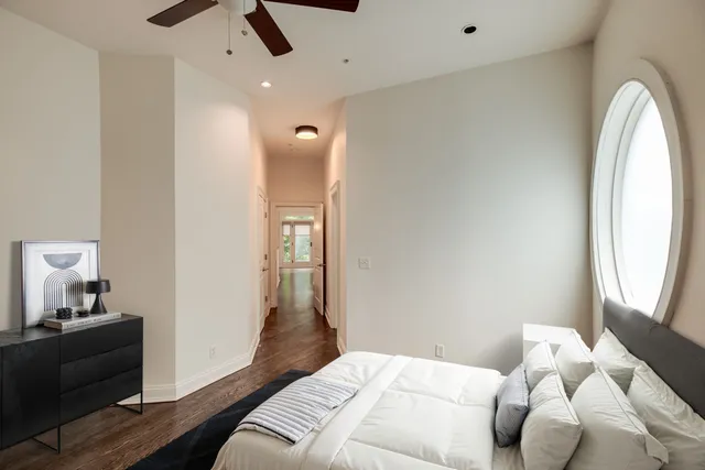 a bedroom with a bed and a mirror