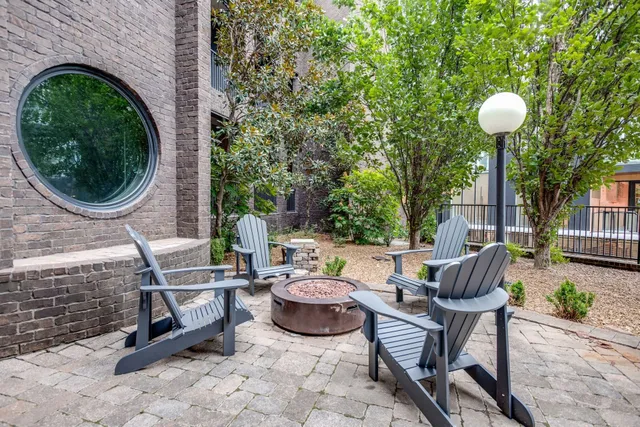 a view of an outdoor sitting area with brick walls