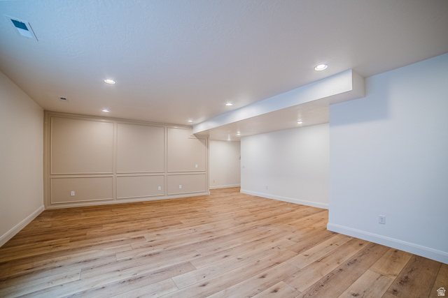 223 South Cottonwood Road, Unit 7501 Vineyard, UT 84059 - Photo 6 of 45 Spacious room featuring wood-finish flooring, recessed lighting, and decorative wall paneling