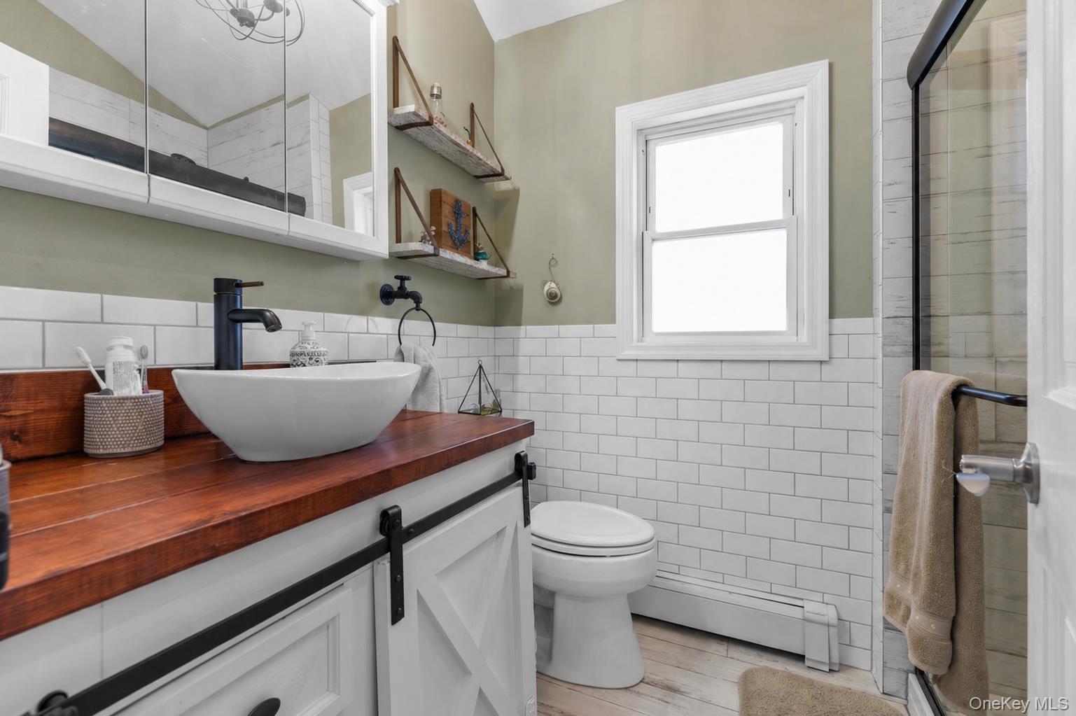 61 Winthrop Road Plainview, NY 11803 - Photo 23 of 37 a bathroom with a toilet a sink and mirror