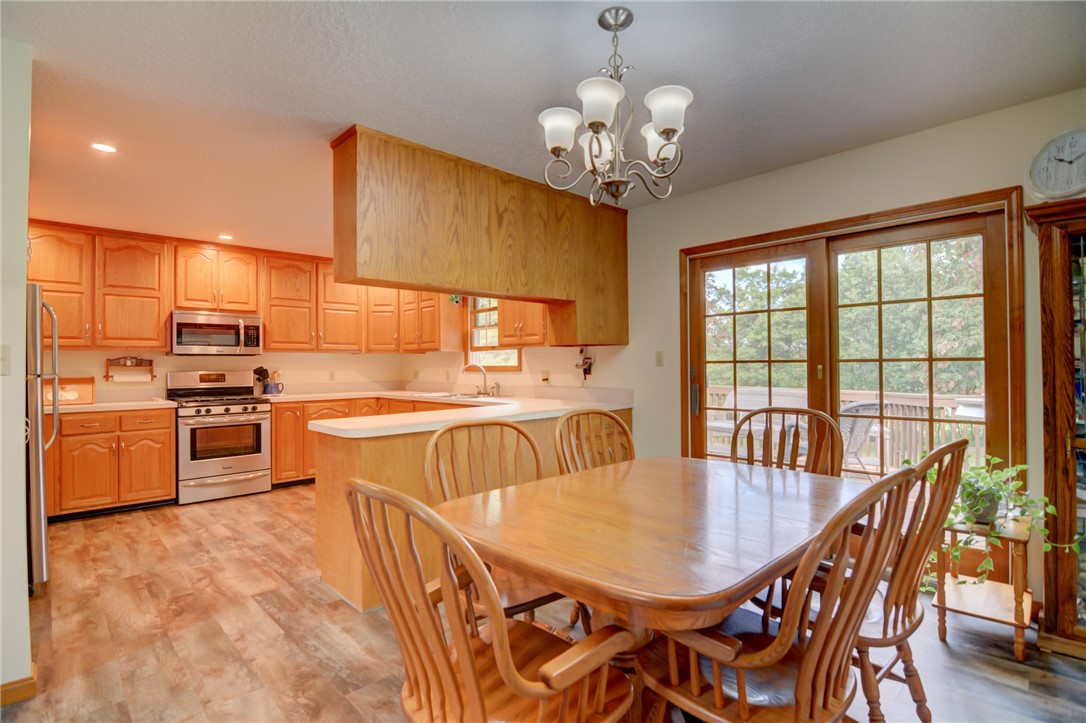 9234 Cabin Road Argenta, IL 62501 - Photo 24 of 47 a view of a dining room with furniture a chandelier and wooden floor