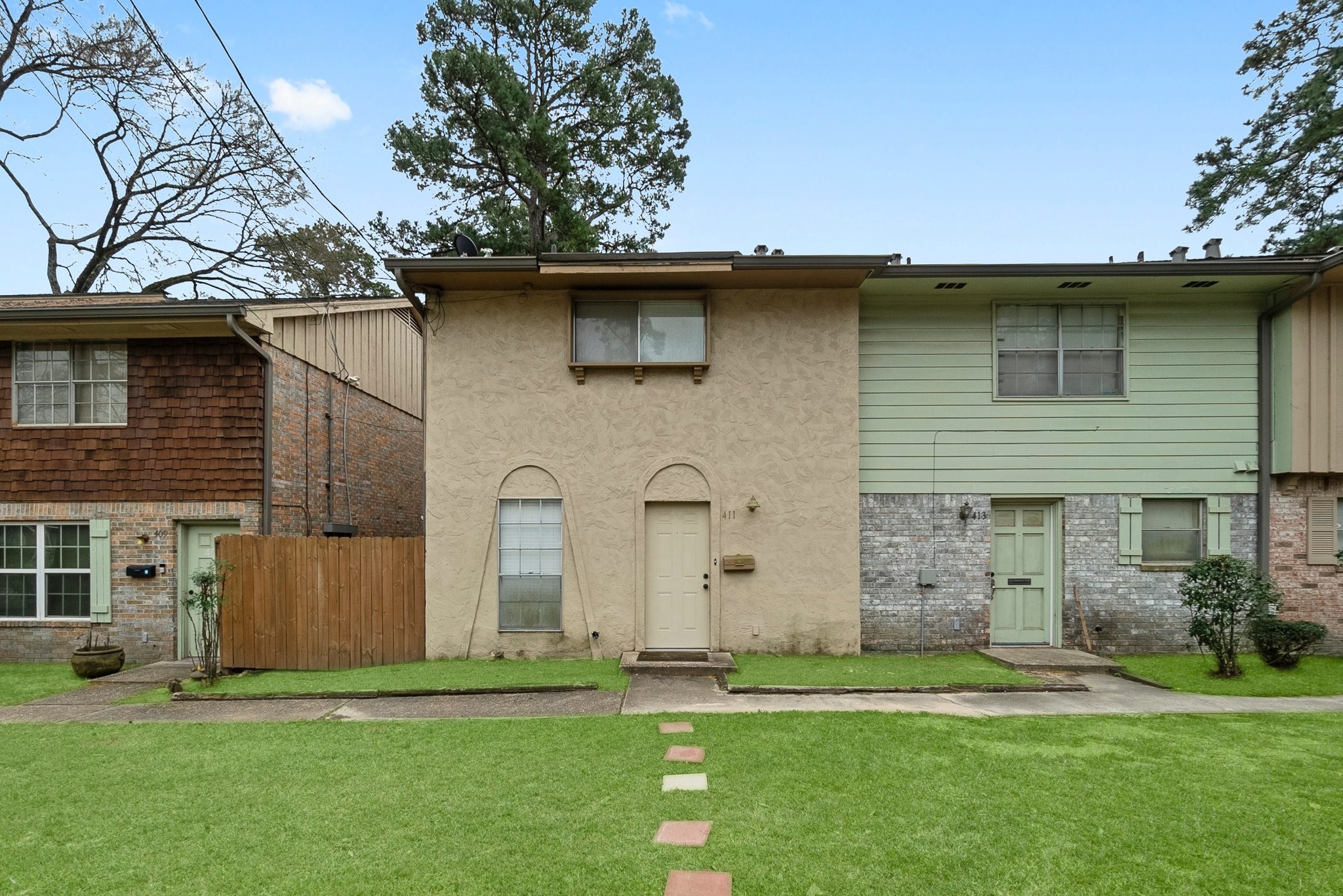 407 West Semands Street Conroe, TX 77301 - Photo 5 of 28 a front view of a house with a garden