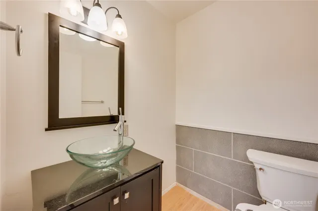 a bathroom with a toilet a sink and mirror