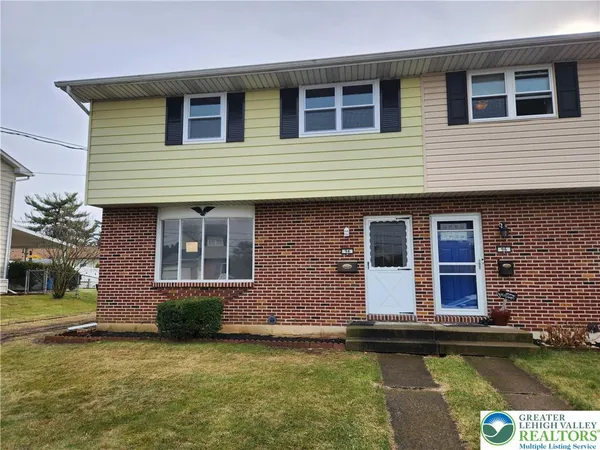 a view of a brick house with a large windows