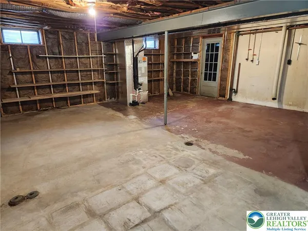a view of an empty room with furniture and storage