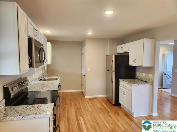 a kitchen with a sink stove and refrigerator