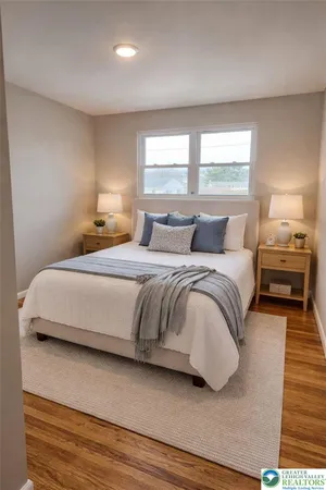 a bedroom with a bed and a night stand