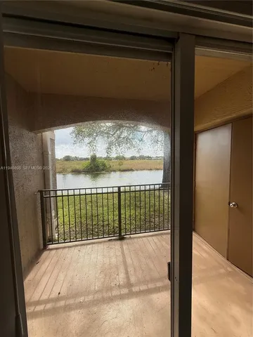 a view of a kitchen with wooden floor and a sink