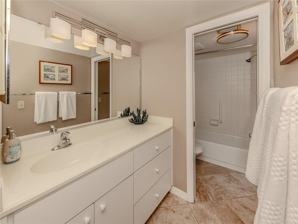 437 Cerromar Lane, Unit 312 Venice, FL 34293 - Photo 16 of 68 a bathroom with a tub sink and mirror
