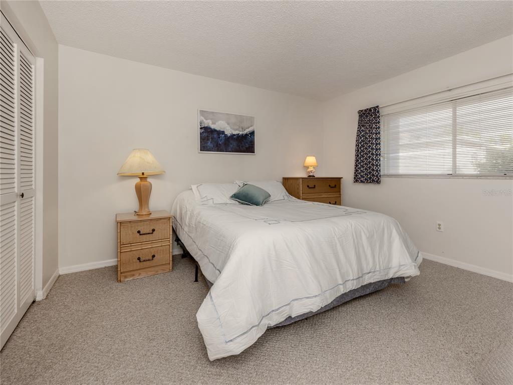 437 Cerromar Lane, Unit 312 Venice, FL 34293 - Photo 17 of 68 a bedroom with a bed and a window