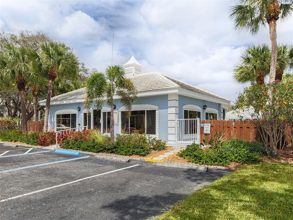 437 Cerromar Lane, Unit 312 Venice, FL 34293 - Photo 30 of 68 a front view of house with yard and trees around